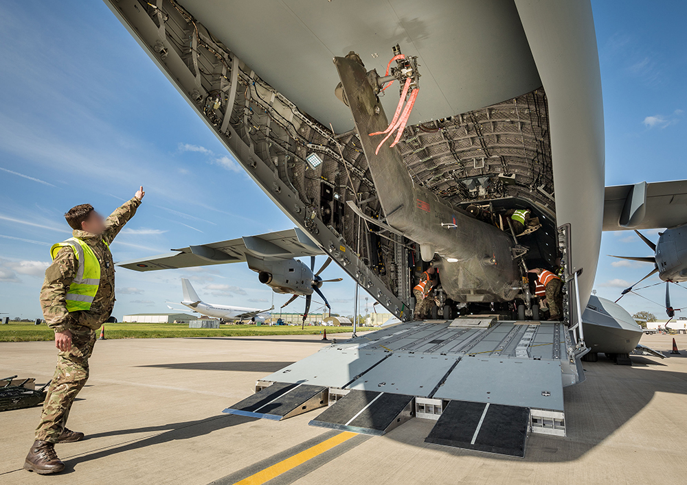 Photo: A RAF Puma helicopter being loaded onto an Atlas aircraft at RAF Brize Norton